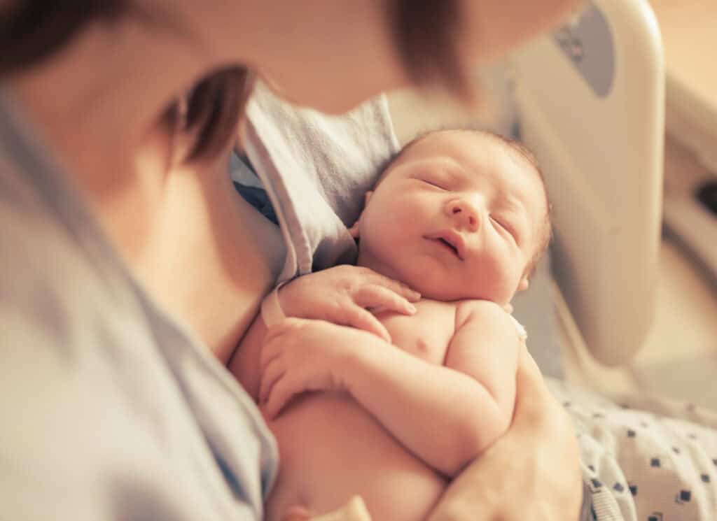 Parenting and new life concept. Mother holding newborn baby boy Parenting and new life concept. Mother holding newborn baby boy