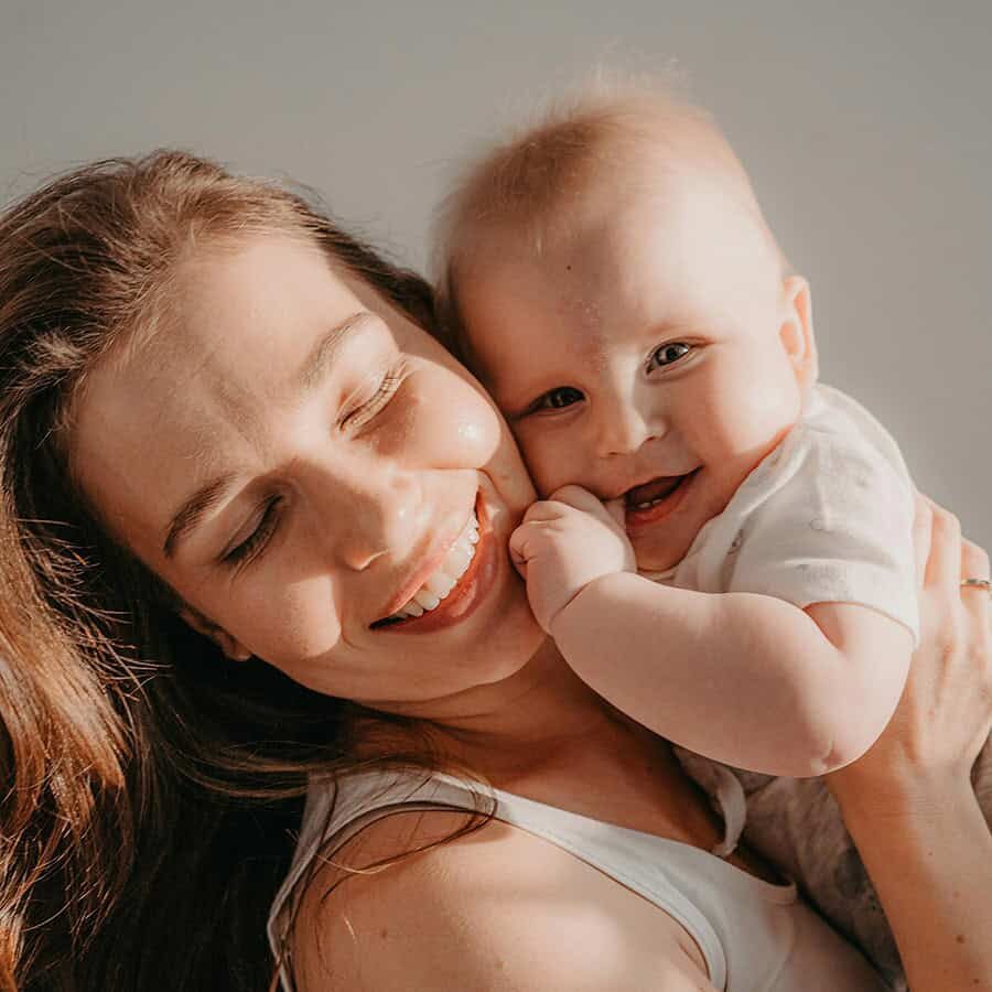 crop 9 A woman holding a baby and smiling.